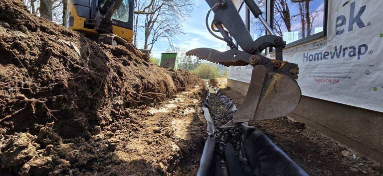 Heavy machinery with bucket excavator moving dirt pile at construction site on sunny day